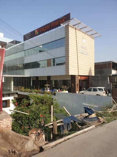 a building with a sign on the front of it at Hotel President in Bharwain