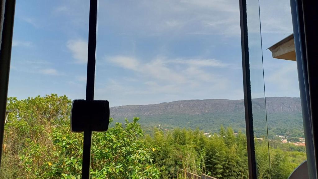a view of the mountains from a window at Pouso Flor da serra in Tiradentes
