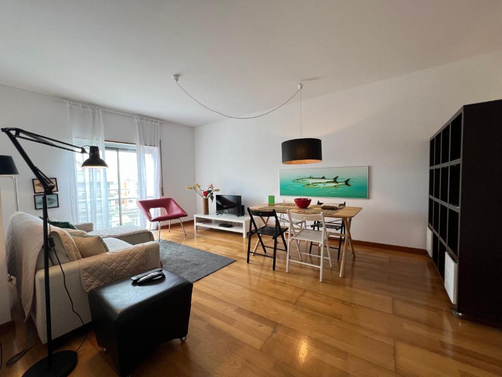 a living room with a couch and a table at Apartamento do Atlântico in Ponta Delgada