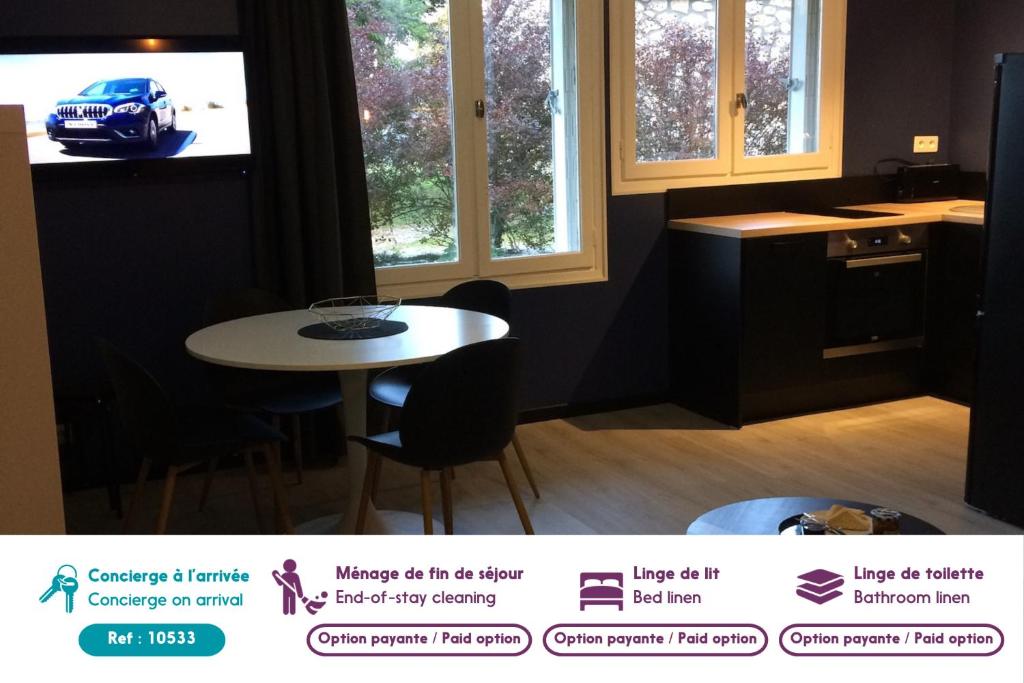 a kitchen with a white table and a blue car on the tv at Appartement Alpin à 200m des pistes pour 6 in Val Louron