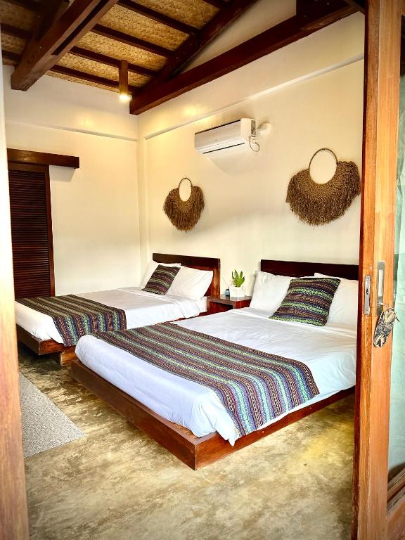 Postel nebo postele na pokoji v ubytování Yumi Villas