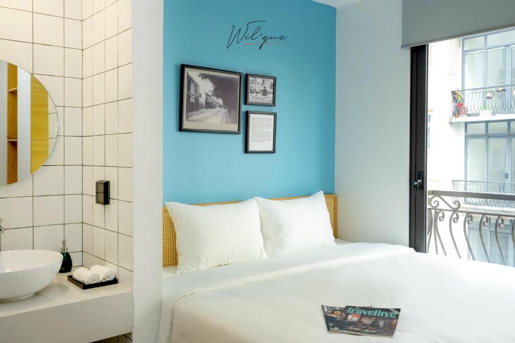 Postel nebo postele na pokoji v ubytování Wilque Hotel Hanoi