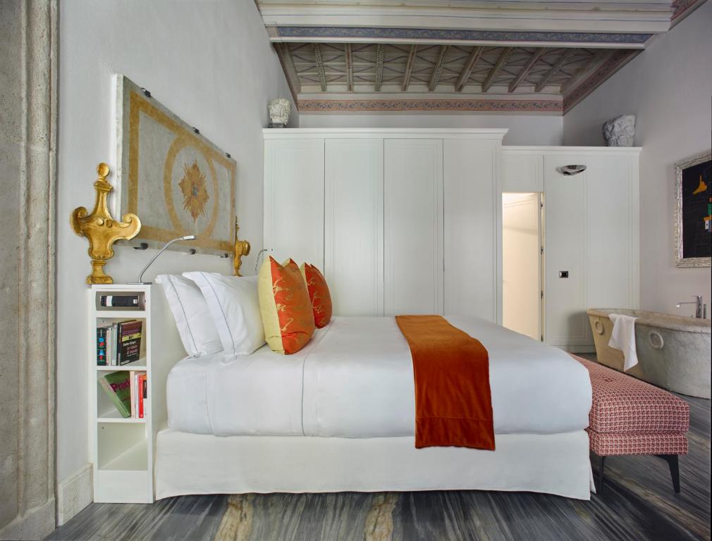 A bed or beds in a room at Palazzo Delle Pietre - Luxury Apartments