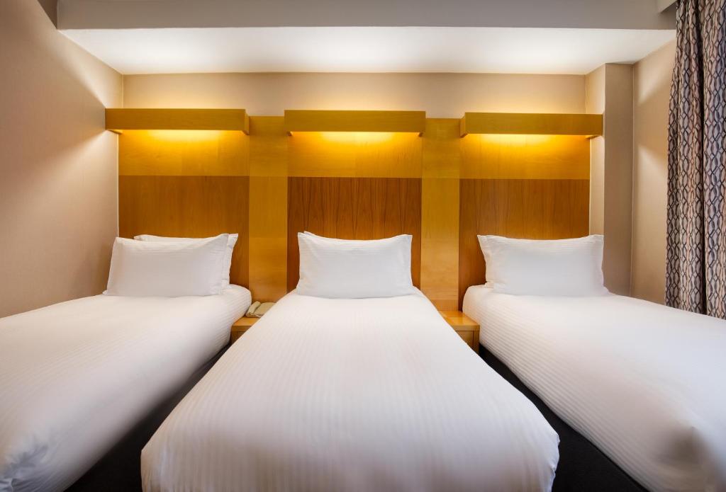 Postel nebo postele na pokoji v ubytování Tavistock Hotel