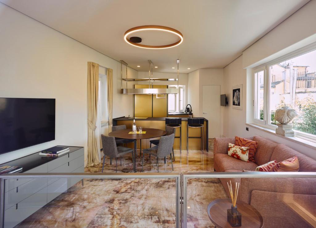 A television and/or entertainment centre at Palazzo Delle Pietre - Luxury Apartments