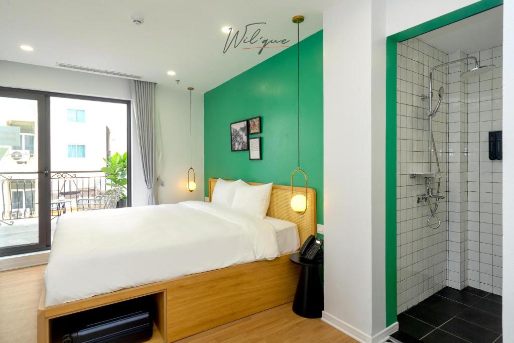 Postel nebo postele na pokoji v ubytování Wilque Hotel Hanoi