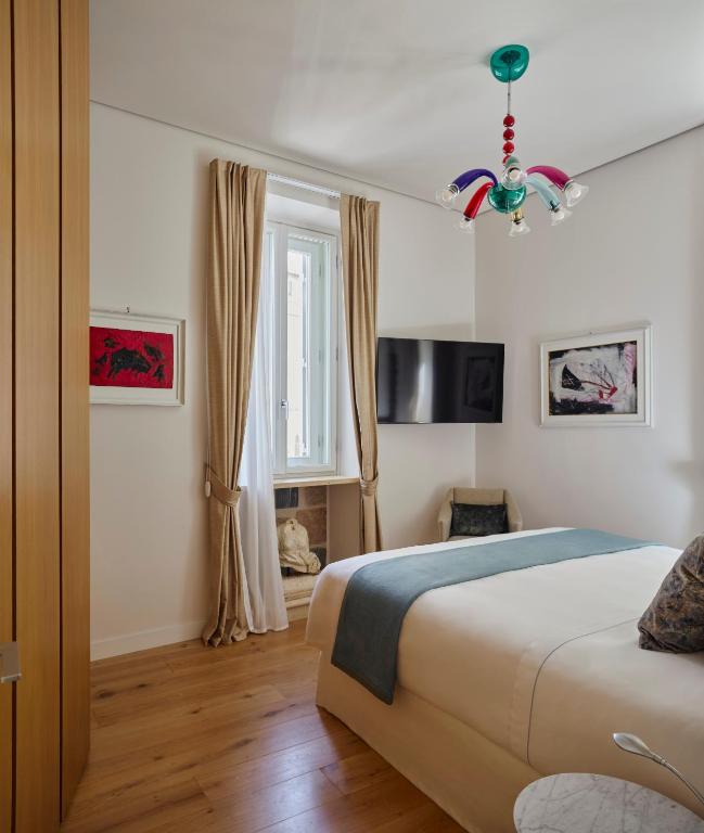 A bed or beds in a room at Palazzo Delle Pietre - Luxury Apartments