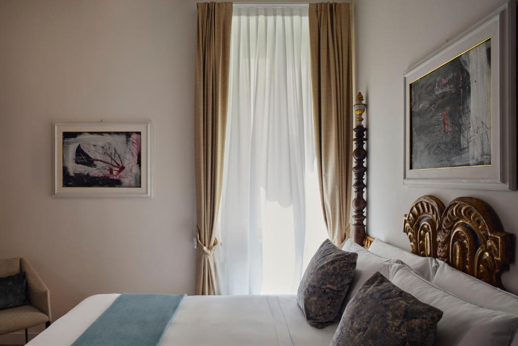 A bed or beds in a room at Palazzo Delle Pietre - Luxury Apartments