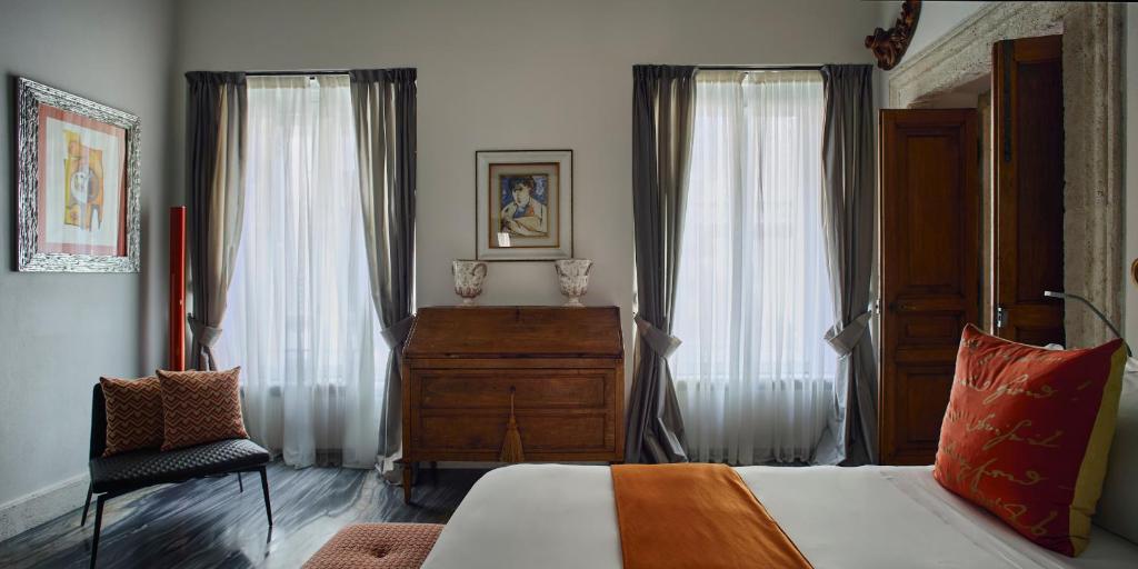A bed or beds in a room at Palazzo Delle Pietre - Luxury Apartments