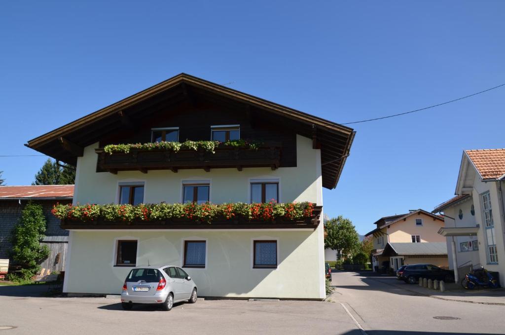 a house with a car parked in front of it at Haus Sennweg in Tannheim