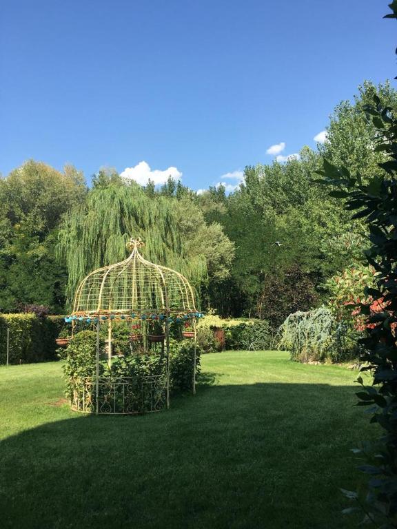 a garden with a gazebo in the grass at B&B La Voliera in Sulmona