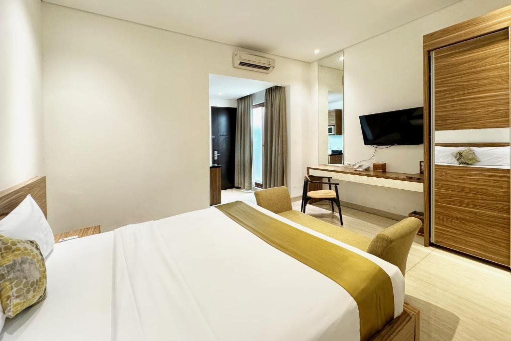 Postel nebo postele na pokoji v ubytování Rasuna Icon Hotel