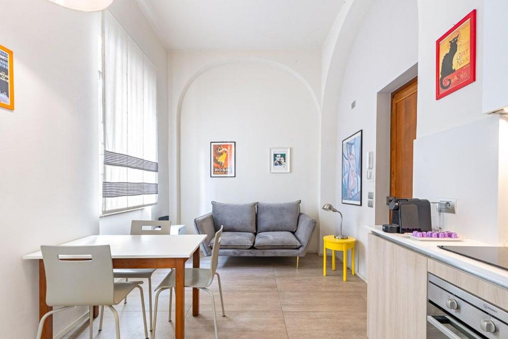a kitchen and dining room with a table and a couch at Casa Pertinace in Alba