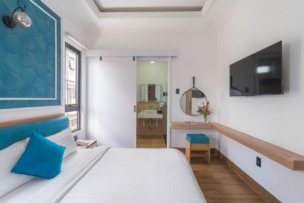 Postel nebo postele na pokoji v ubytování VMT Hotel Da Lat