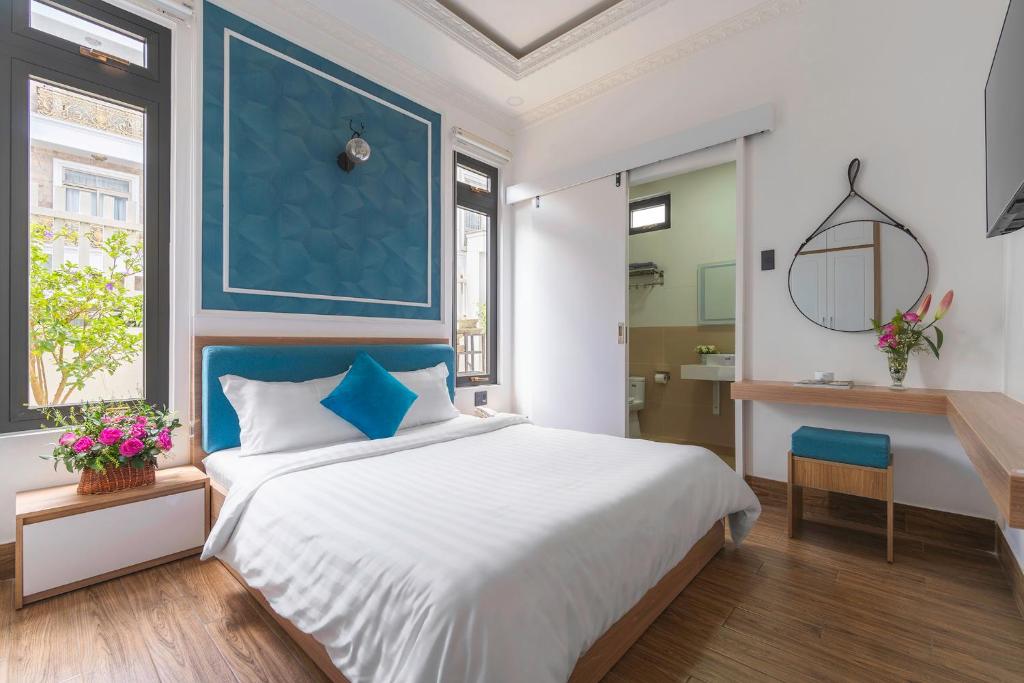 Postel nebo postele na pokoji v ubytování VMT Hotel Da Lat