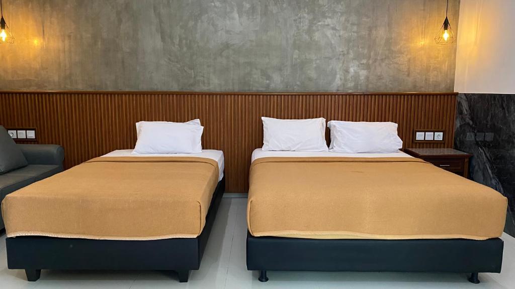 Postel nebo postele na pokoji v ubytování Sandat Hotel Legian
