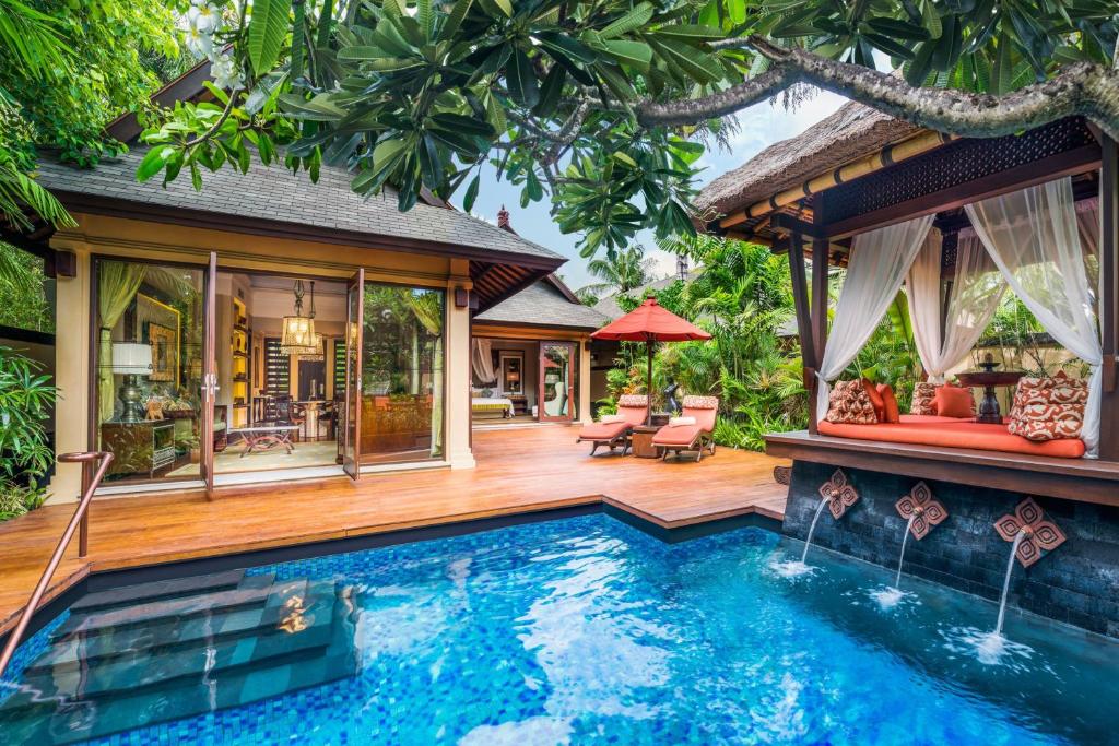 a villa with a swimming pool and a house at The St. Regis Bali Resort in Nusa Dua