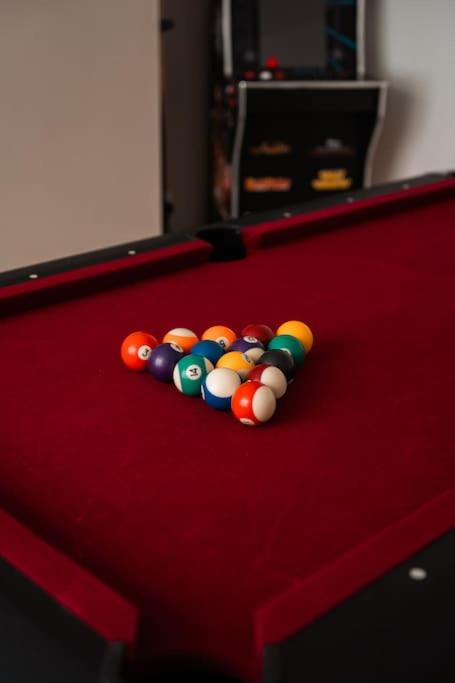 a group of cue balls on a pool table at Contractor-Friendly 3-Bed, Games Room, Pool Table! in Enfield Lock
