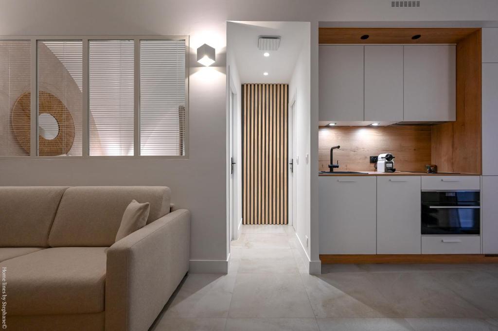 un salon avec un canapé et une cuisine dans l'établissement Ancienne cave de pêcheur, à La Ciotat