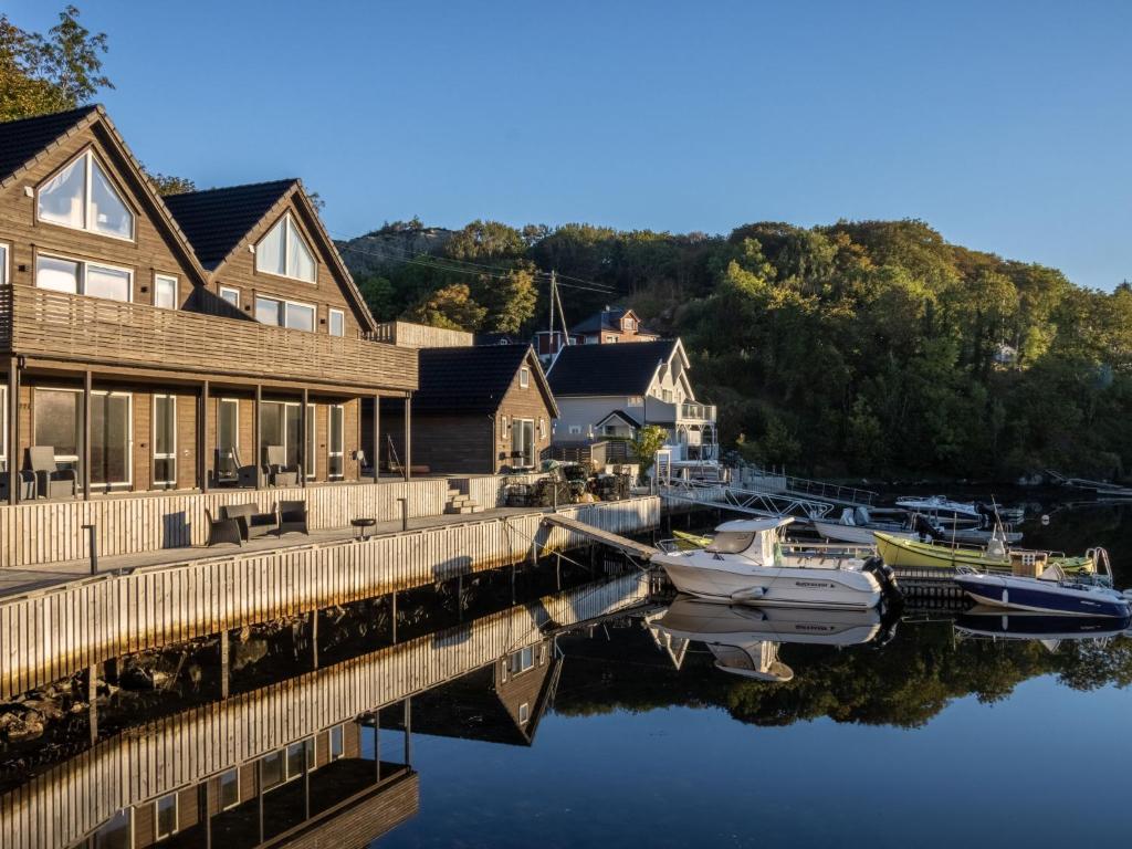 a boat is docked at a dock next to a house at Holiday Home Lange by Interhome in Bømlo