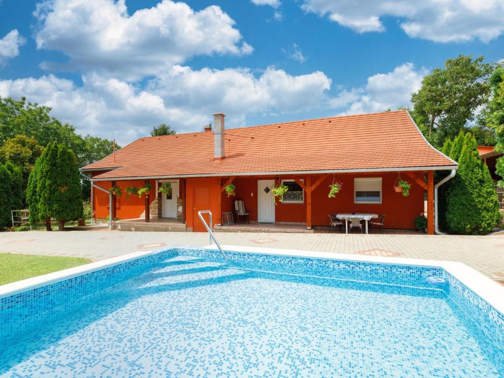 a house with a swimming pool in front of a house at Holiday Home Brigi by Interhome in Balatonszárszó