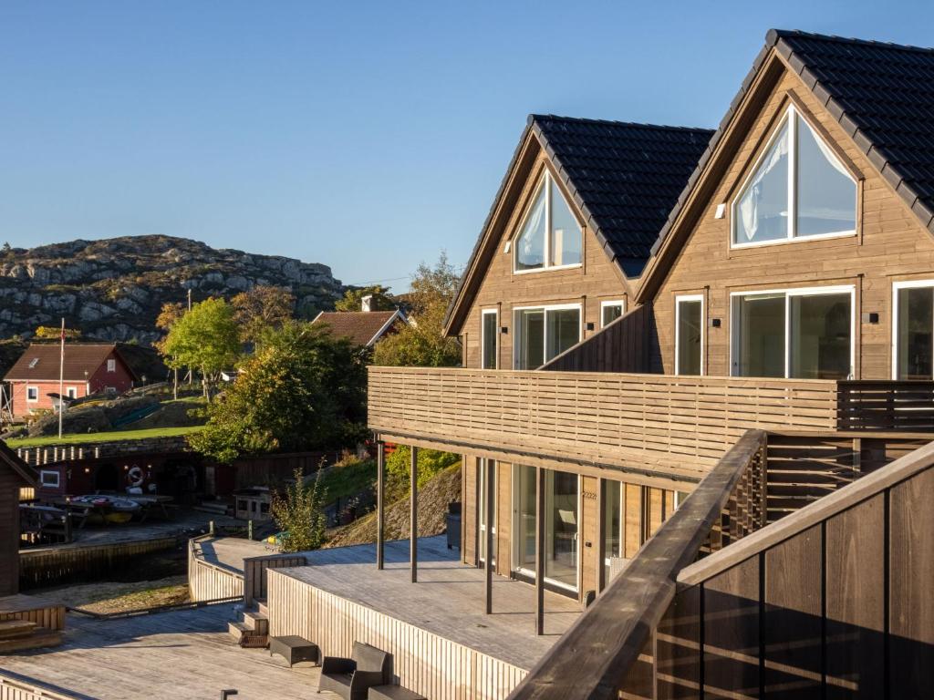 a wooden house with a deck and stairs at Holiday Home Brosme by Interhome in Bømlo