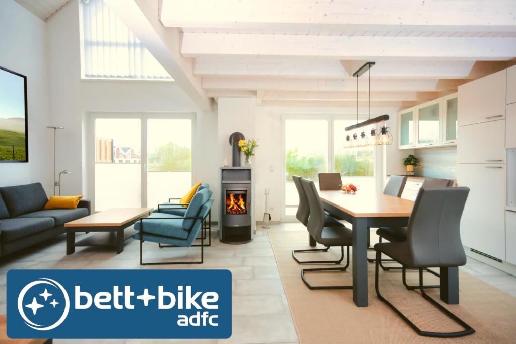 a living room with a table and chairs and a fireplace at Blinkfüer in Nordhorn