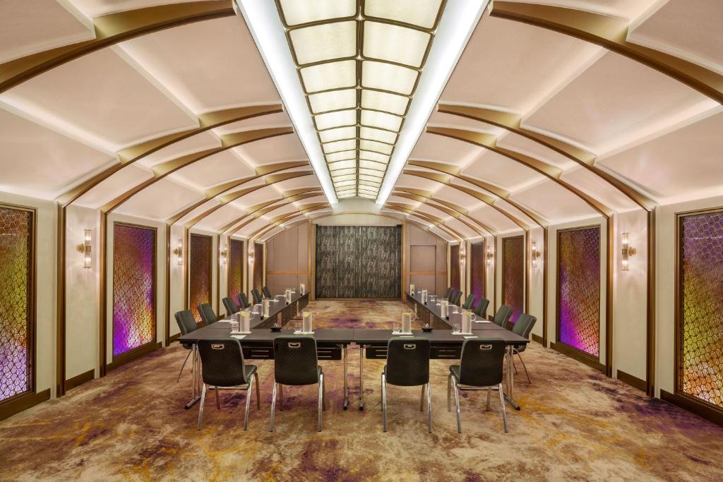 a conference room with a long table and chairs at W Bangkok Hotel in Bangkok