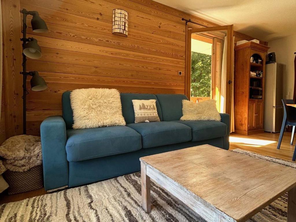 un salon avec un canapé bleu et une table dans l'établissement Appartement 2 pièces cabine 3* pour 6 pers avec piscine, balcon et parking privé, proche télésiège - FR-1-263-408, à Valloire