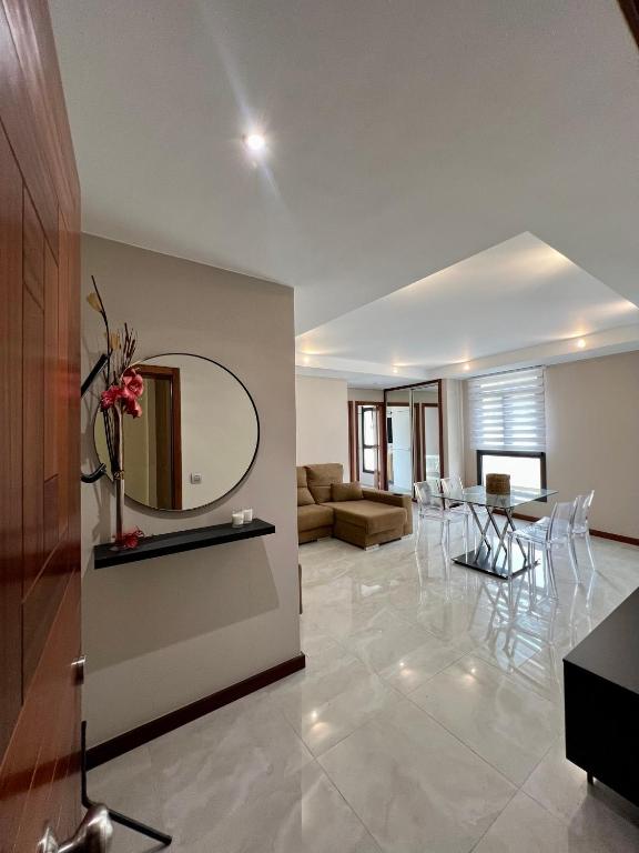a living room with a table and a mirror at Detail Tacoronte in Tacoronte