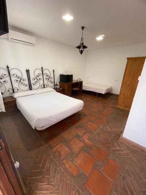 Postel nebo postele na pokoji v ubytování La Hacienda del Marquesado