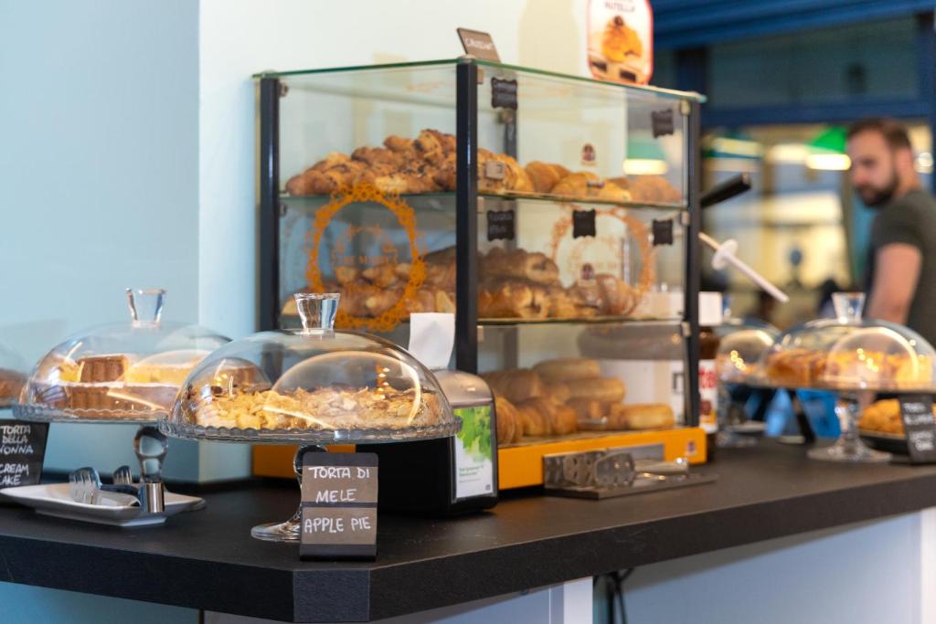a bakery with a display of pastries on a counter at Plus Florence in Florence