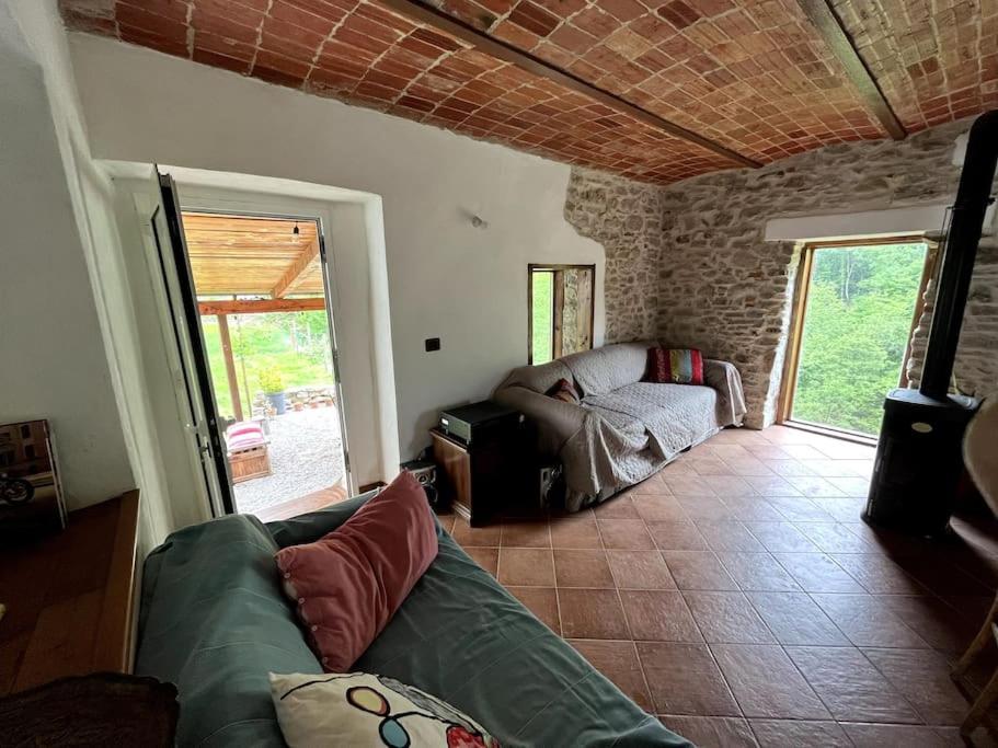 a living room with a couch and a table at Casa Camerana 16 personnes in Camerana 