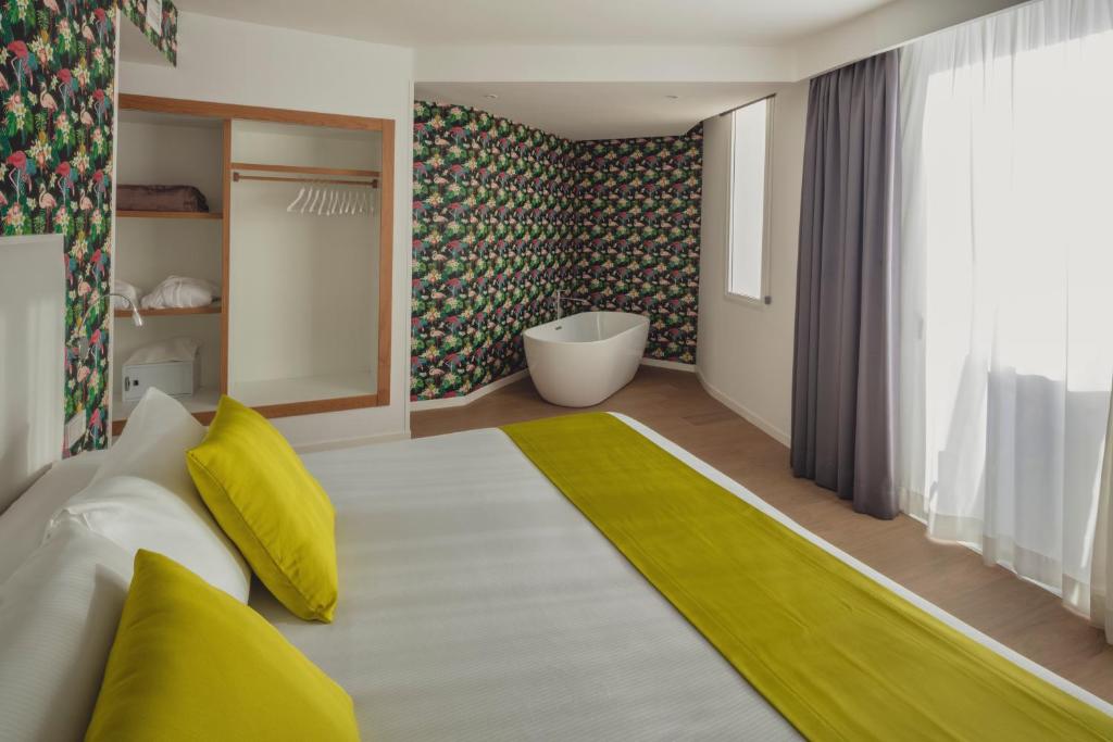 a living room with a white couch and a bath tub at Flamingo Beach Mate in Adeje