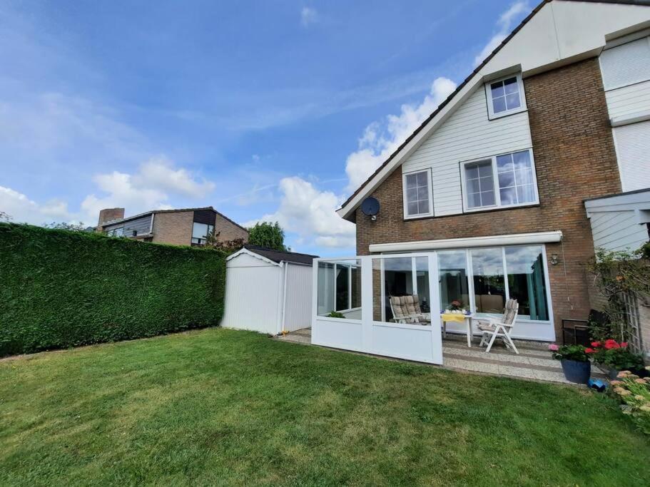 ein Haus mit einem Hinterhof mit einem weißen Zaun in der Unterkunft Lamsoor 20 in Nieuwvliet