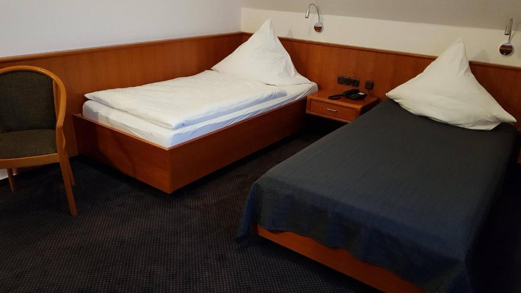 Postel nebo postele na pokoji v ubytování Hotel Walz