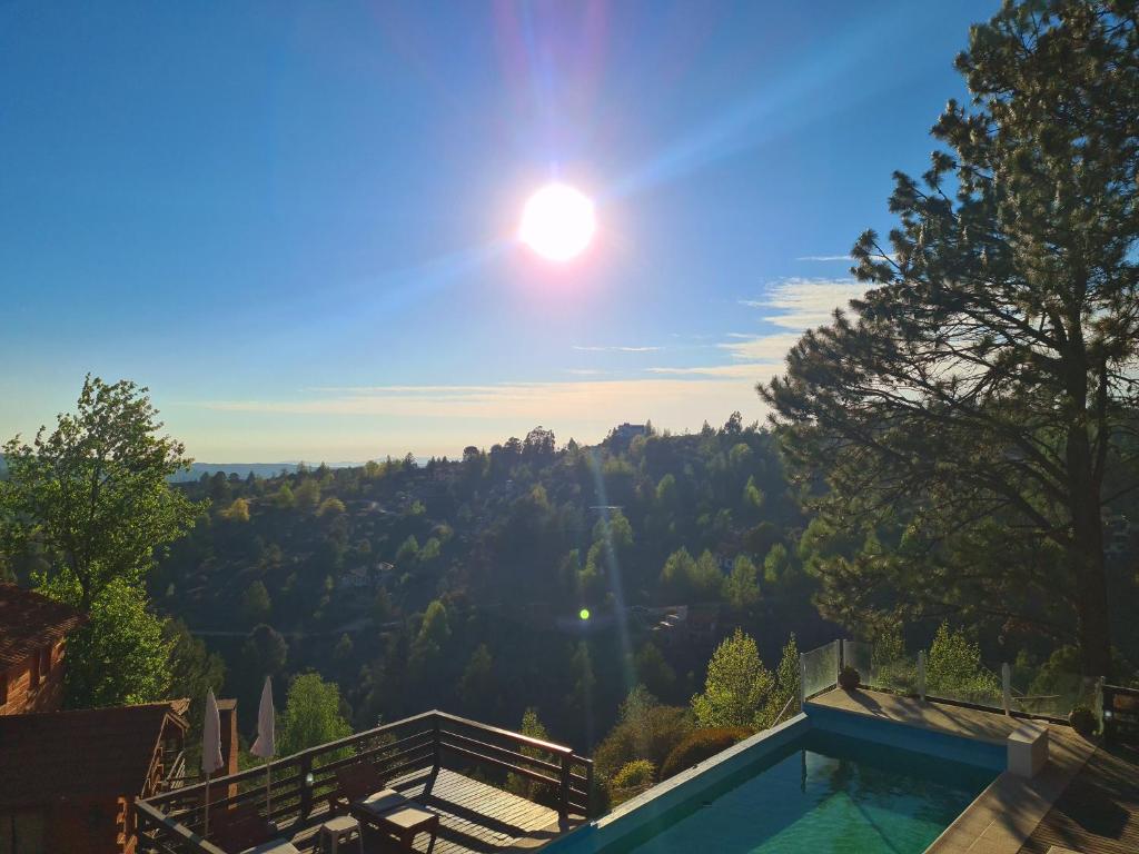a swimming pool with a view of a mountain at Cabañas del Peñón in La Cumbrecita