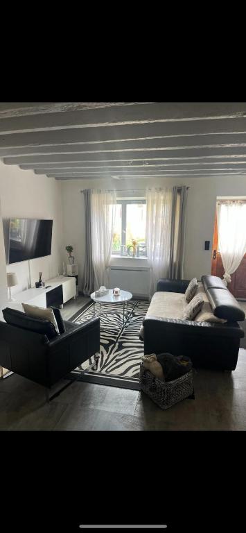 un salon avec un lit et un canapé dans l'établissement Maison de village, à Villeroy