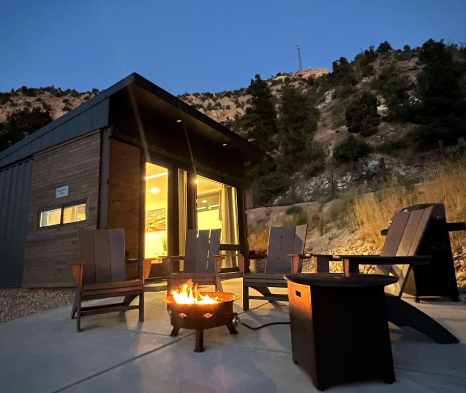 a log cabin with a fire in front of it at Mountain View in Orderville
