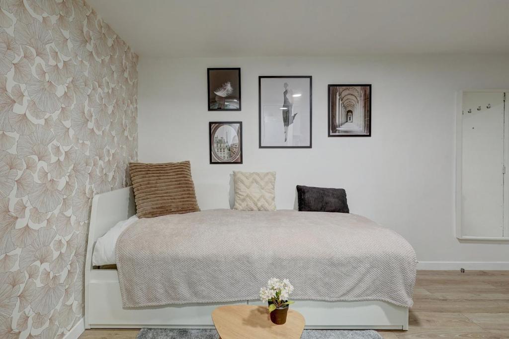 - une chambre avec un lit et des photos sur le mur dans l'établissement Élégant studio de prestige au cœur de Paris, à Paris