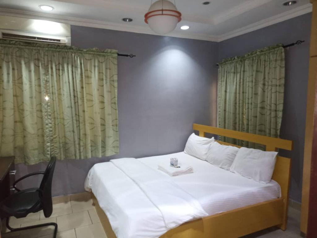 Rúm í herbergi á Haute Aparthotel