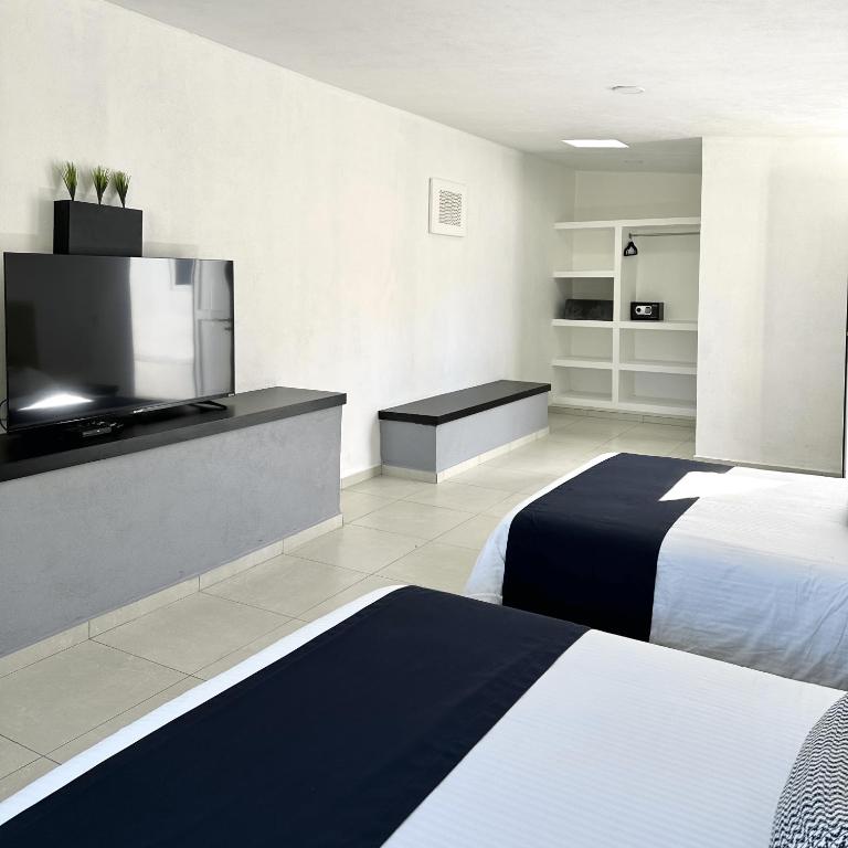 Postel nebo postele na pokoji v ubytování DUNAMIS HOTEL