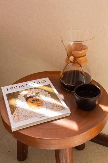 a table with a book and a blender on a table at Chic Loft Steps from the Beach in Holbox Island