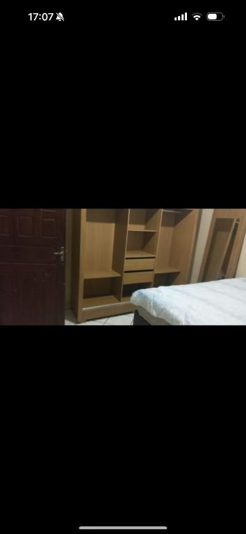 a picture of a bedroom with a bed and wooden cabinets at Casa Da Mic in Parauapebas