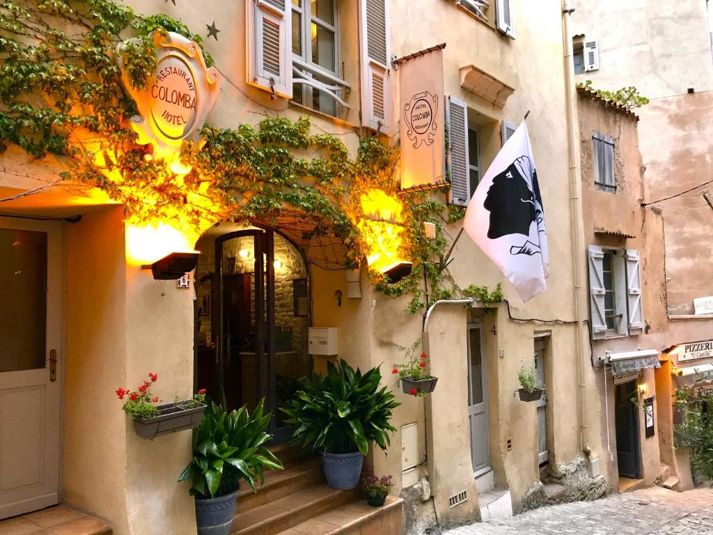 博尼法乔Colomba Hôtel Centre-Ville Historique的一栋侧面摆放着盆栽的建筑物