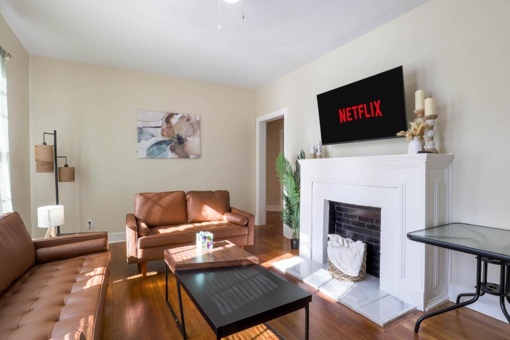 a living room with a couch and a fireplace at Backyard Beauty Bungalow in Jackson in Jackson