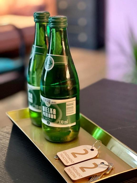two bottles of beer sitting on a tray at Restauracja Pałacowa Apartamenty in Radzyń Podlaski