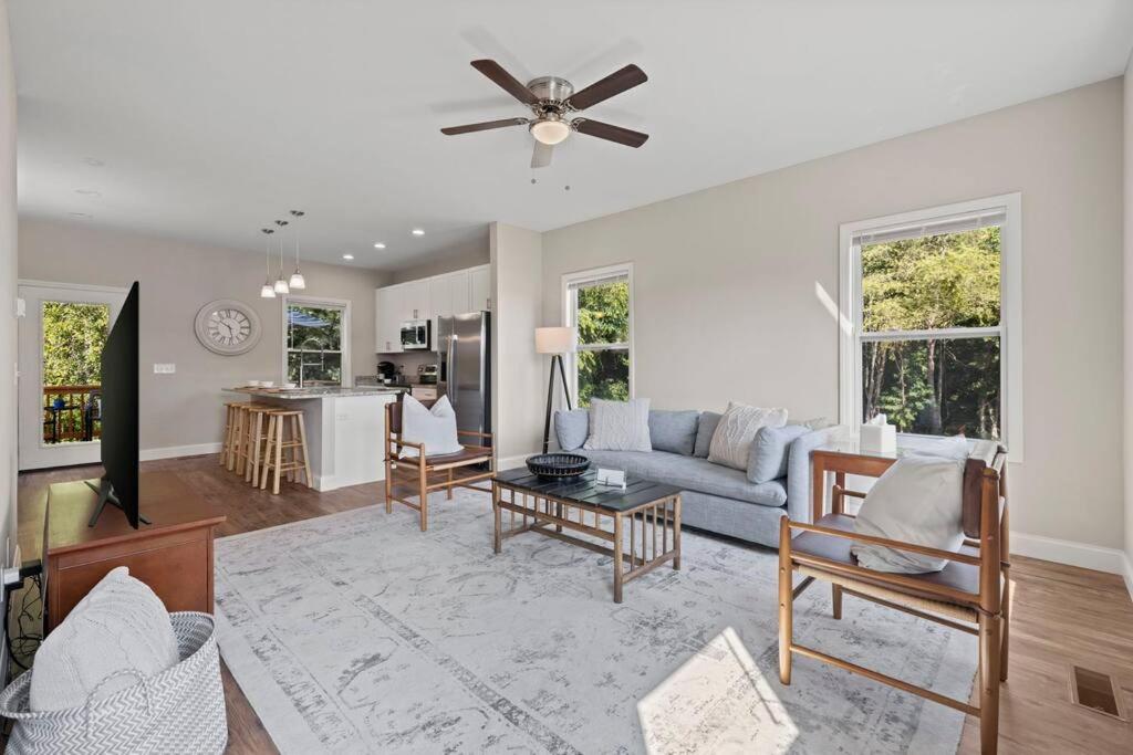 a living room with a couch and a table at Water,Power,WIFI- 10 Min to Downtown AVL in Asheville