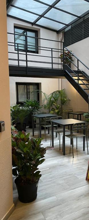 a patio with tables and benches in a building at Charcas Suites Palermo Soho in Buenos Aires
