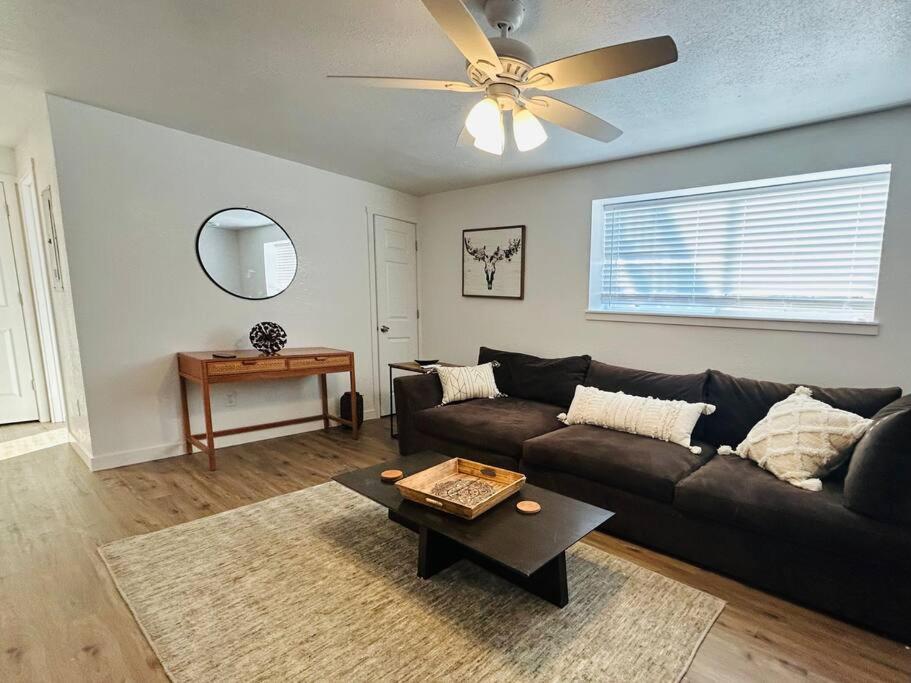 a living room with a couch and a ceiling fan at WesterHaven- 2 bd Garden Level in Nampa